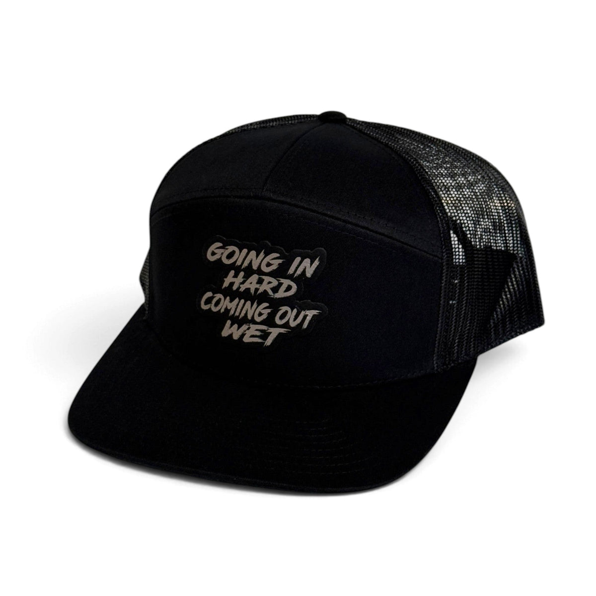 Crafted Merch black trucker hat with a structured front panel, breathable mesh back, and a bold text patch.