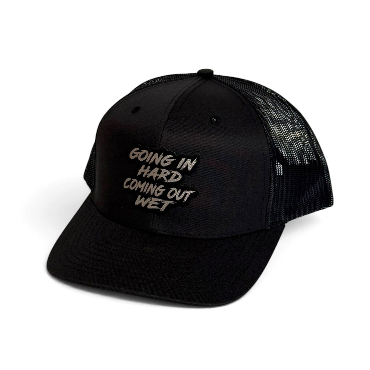 Crafted Merch black trucker hat with a mesh back and a patch featuring the text Going In Hard Coming Out Wet