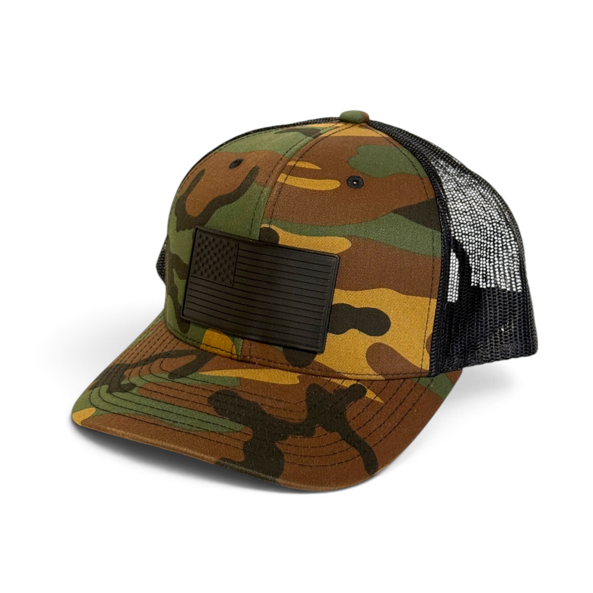 Crafted Merch camo trucker hat with a black monochromatic American flag PVC patch and breathable black mesh back