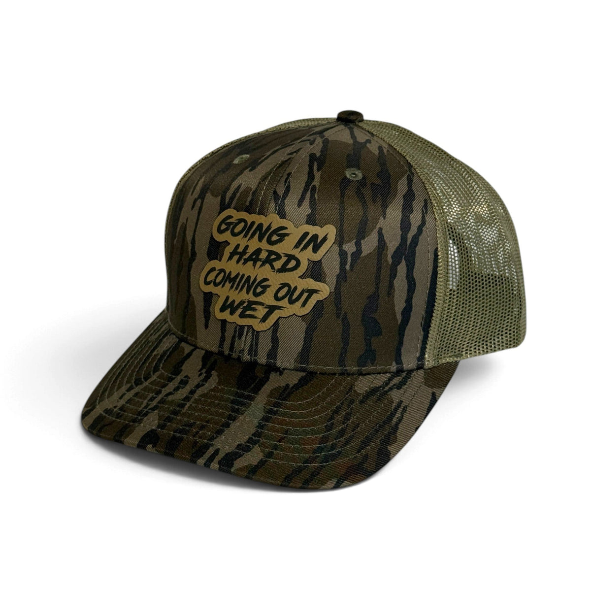 Crafted Merch trucker hat in camo print with a tan mesh back and a patch reading Going In Hard Coming Out Wet