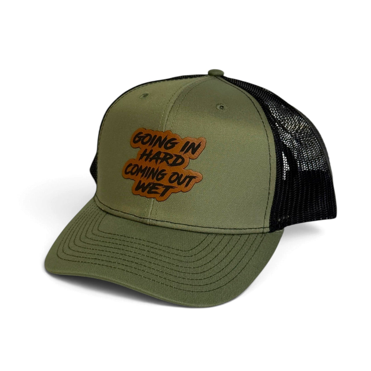 Crafted Merch olive green trucker hat with a black mesh back and a brown patch featuring bold text.
