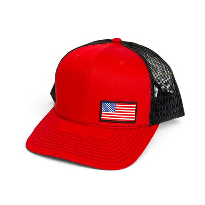 Crafted Merch red and black trucker hat featuring a full-color American flag PVC patch on the front panel